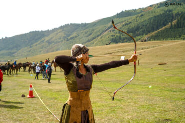 Kyrgyz girl shooting arrows and bow
