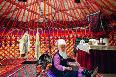 traditional yurt inside with traditional women in Kyrgyzstan