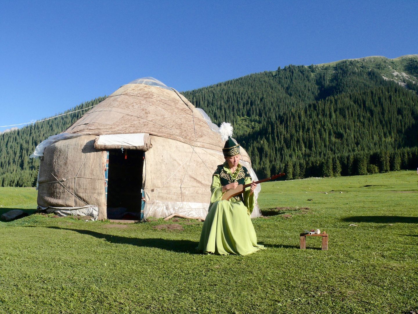 kyrgyz girl singing in fornt of the yurt